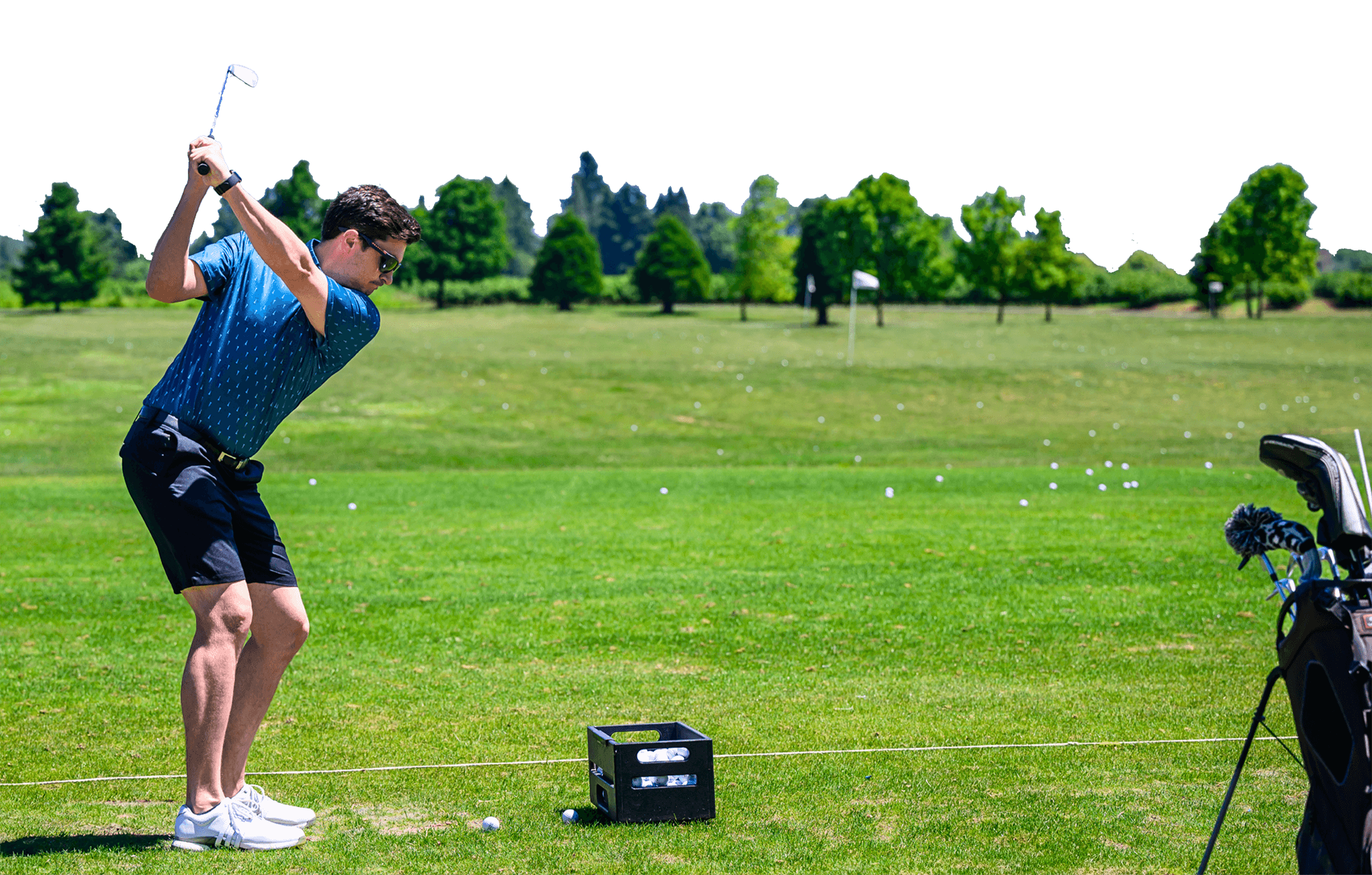 man swinging golf club